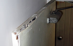 Badly damaged asbestos cored firedoor