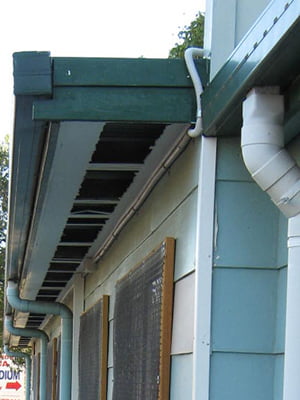 Vandalised asbestos cement sheet eaves lining