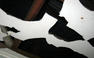 Damaged asbestos cement sheet ceiling