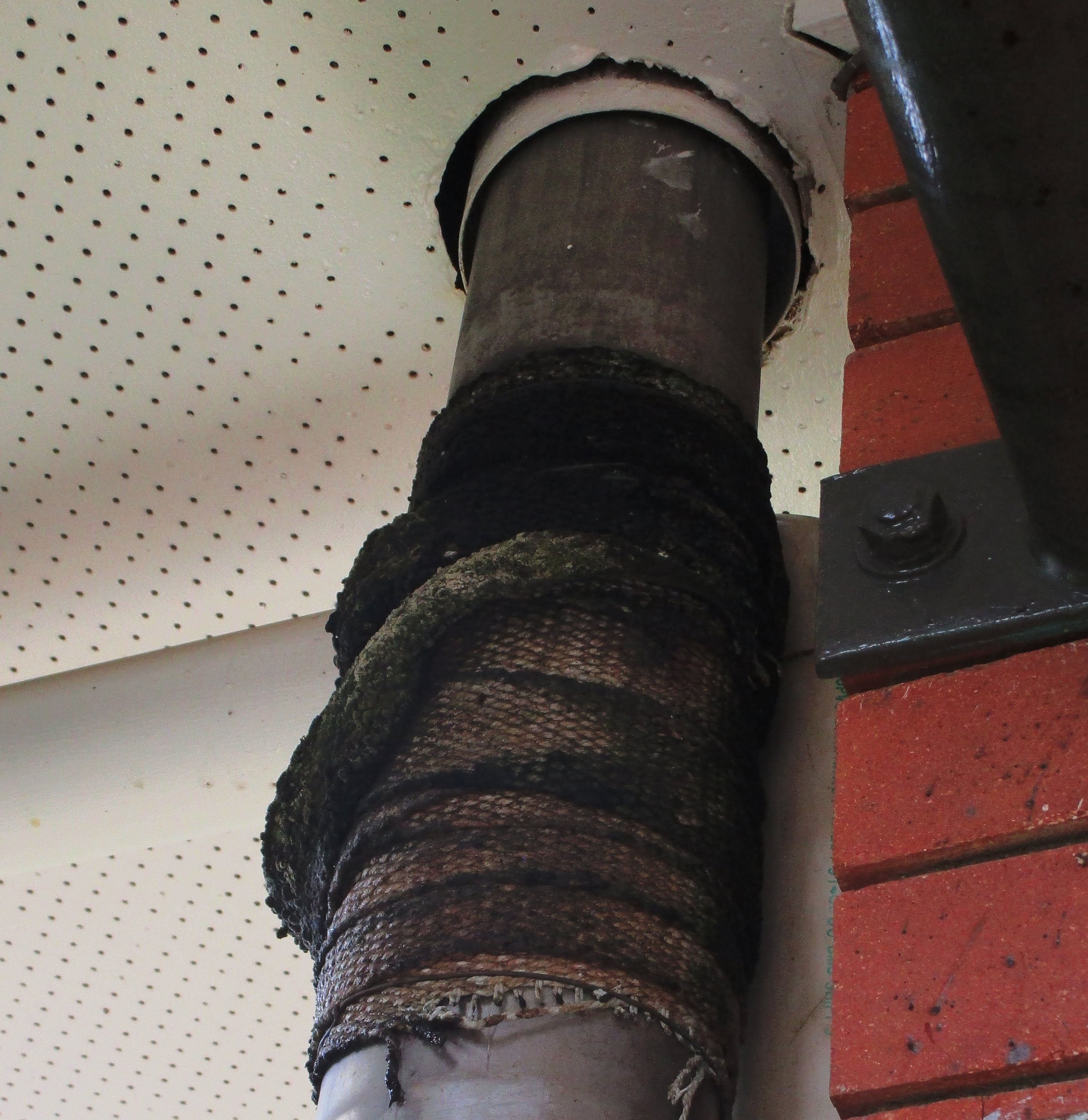 Woven asbestos textile wrap on exhaust pipe